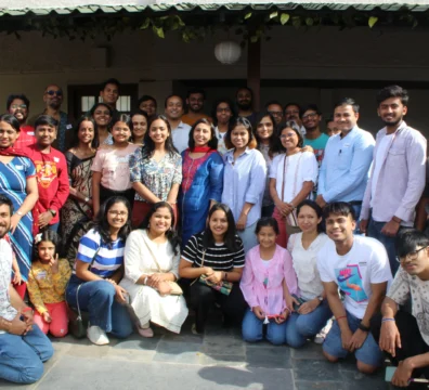 Saachi students and staff posing together at a student gathering